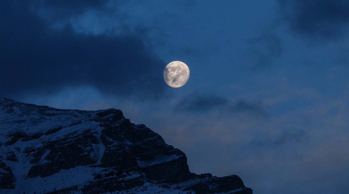 full moon snowy mountain under full moon during nighttime space